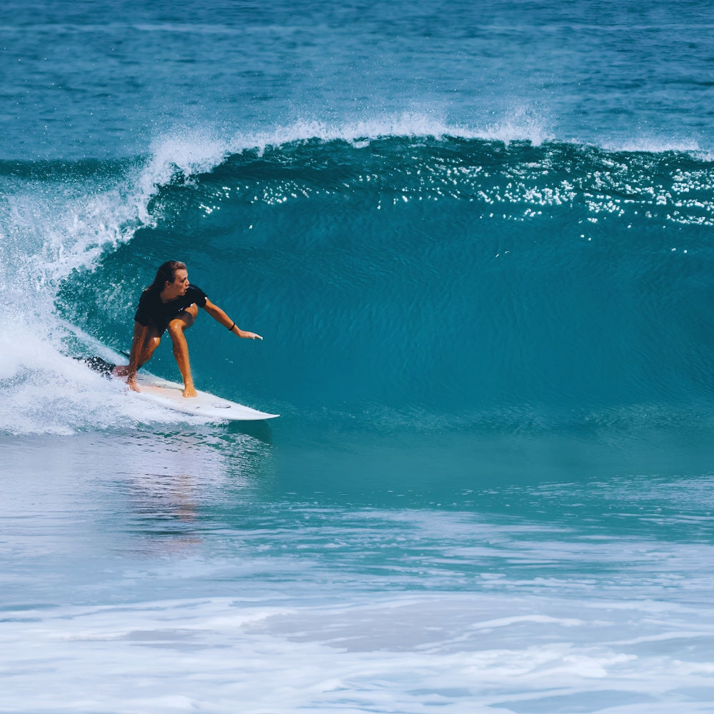 Surf rider on ocean wave showing rail-to-rail surf movement