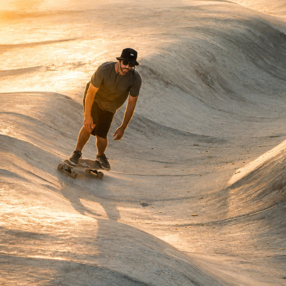 Rider carving in a concrete bowl on a SpiceSkate OktoAIR surfskate